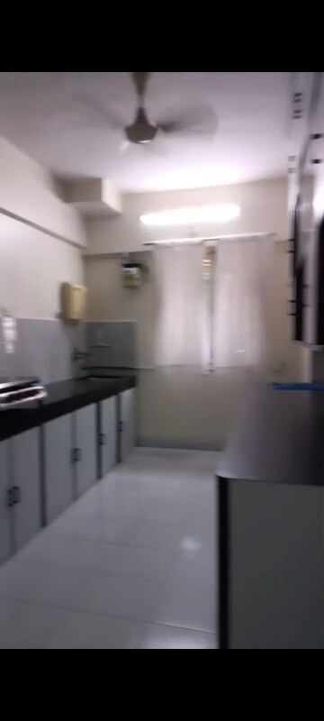 Kitchen in 2 BHK Apartment at Crystal Garden Estate CHS, Manpada – for Sale