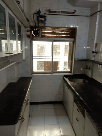 Kitchen in 1 BHK Apartment at Dheeraj Uphar CHS. LTD., Malad East – for Sale