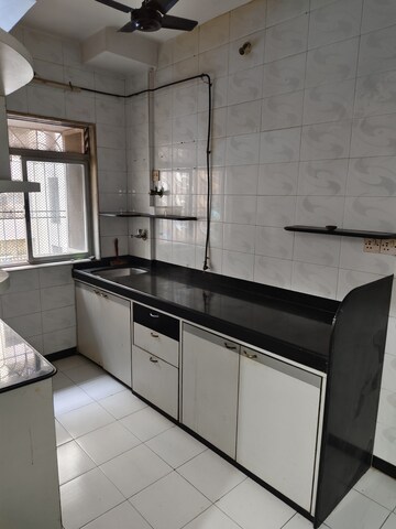 Kitchen in 1 BHK Apartment at Dheeraj Uphar CHS. LTD., Malad East – for Rent