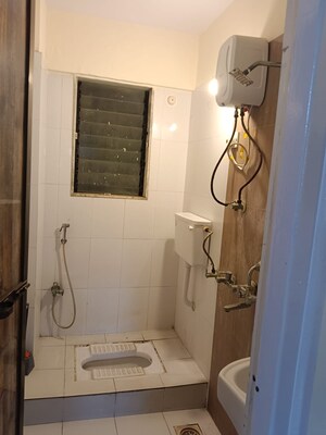 Bathroom in 1 BHK Apartment at Raunak Unnathi Woods Phase 4 And 5, Ghodbunder Road – for Sale