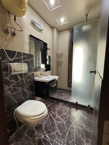 Bathroom in 4 BHK Builder Floor at Green Park Extension – for Rent