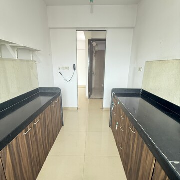 Kitchen in 2 BHK Apartment at Rustomjee Athena, Vrindavan Society – for Rent