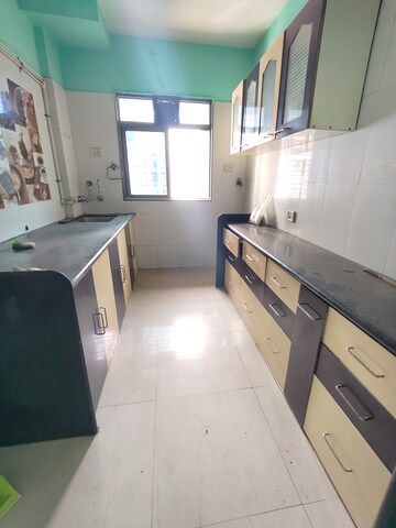 Kitchen in 2 BHK Apartment at Osho Dhara Residency, Khadakpada – for Rent