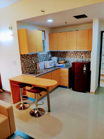 Living Room in Studio Apartment at Supertech Czar Suites, Omicron I Greater Noida – for Rent