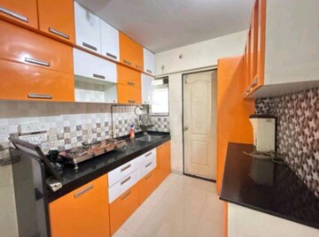 Kitchen in 1 BHK Apartment at Cosmos Orchid, Ghodbunder Road – for Sale