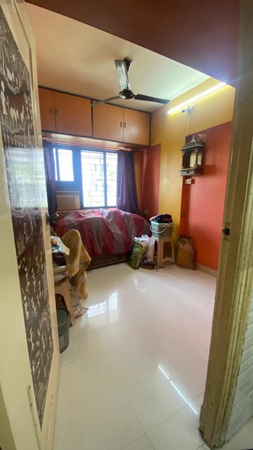 Bedroom in 1 BHK Apartment at Divya Gunjan CHS, Kandivali West – for Sale