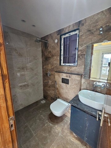 Bathroom in 3 BHK Builder Floor at RWA Parmanand, Mukherjee Nagar – for Sale