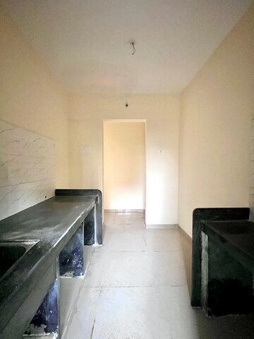 Kitchen in 1 BHK Apartment at Paradigm Zenith Pushpanjali Residency Phase III, Ghodbunder Road – for Sale