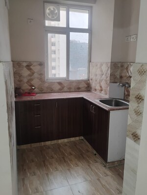 Kitchen in 2 BHK Apartment at Amrapali Golf Homes, Sector 4 Greater Noida – for Rent