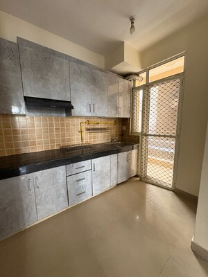 Kitchen in 3 BHK Apartment at Mahagun Mywoods, Sector 16c Greater Noida – for Rent