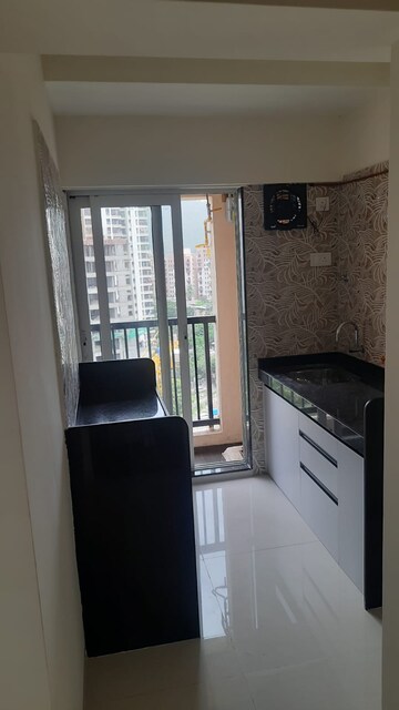 Kitchen in 1 BHK Apartment at Unnathi Woods Phase 1 And 2, Ghodbunder Road – for Rent