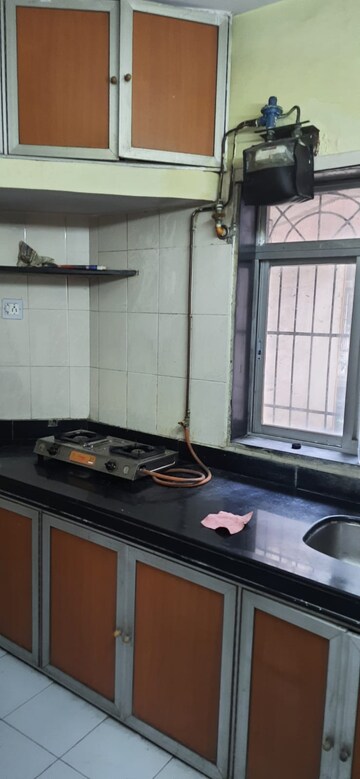 Kitchen in 1 BHK Apartment at Vijay Nagri CHS Ltd Building No 11, Waghbil – for Rent