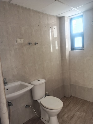 Bathroom in 2 BHK Apartment at Charms Castle Phase II, Raj Nagar Extension – for Rent