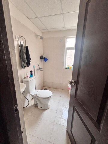 Bathroom in 2 BHK Apartment at Charms Castle Phase II, Raj Nagar Extension – for Rent