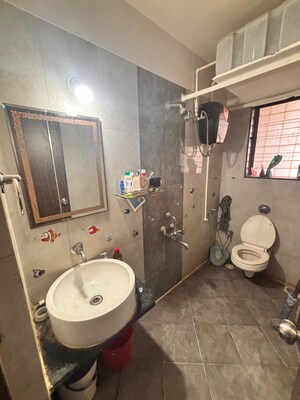 Bathroom in 1 BHK Apartment at Aakar Manas Residency, Naupada – for Rent