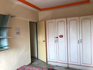 Bedroom in 2 BHK Apartment at Gokuldham Saidham CHS, Goregaon East – for Rent