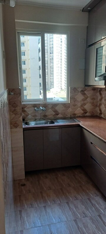 Kitchen in 2 BHK Apartment at Amrapali Golf Homes, Sector 4 Greater Noida – for Rent