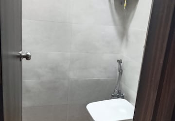 Bathroom in 1 BHK Apartment at Shree Tirupati STG Signature Residency, Patlipada – for Rent