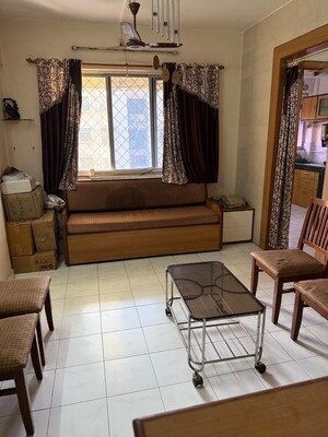 Living Room in 1 BHK Apartment at Swastik Park CHS, Brahmand – for Sale