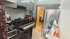 Kitchen in 2 BHK Apartment at Harmony Signature Towers, Owale – for Rent