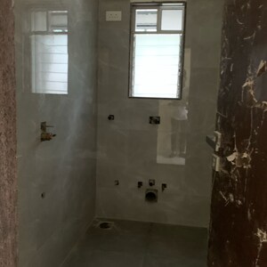 Bathroom in 2 BHK Apartment at Kosmos Kedar Darshan, Kastur Park – for Sale