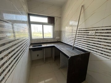 Kitchen in 1 BHK Apartment at Raunak Unnathi Woods Phase 7 A And B, Ghodbunder Road – for Sale