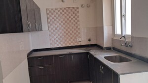 Kitchen in 2.5 BHK Apartment at Amrapali Princely Estate, Sector 76 – for Sale