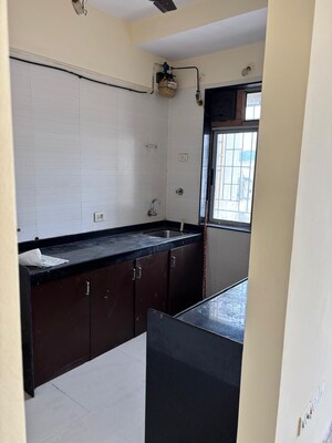 Kitchen in 1 BHK Apartment at Unnati Woods CHS, Kasarvadavali – for Sale