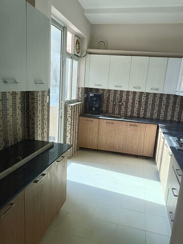 Kitchen in 4 BHK Builder Floor at Ansal API Esencia, Sector 67 – for Rent