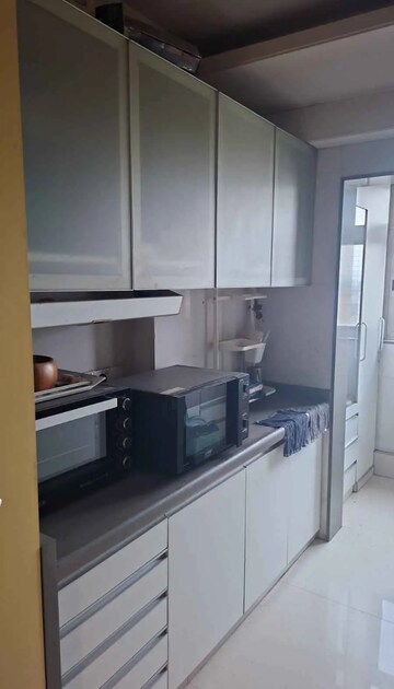 Kitchen in 3 BHK Apartment at Hiranandani Estate Rodas Enclave, Ghodbunder Road – for Rent