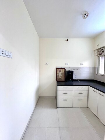 Kitchen in 1 BHK Apartment at Unnati Woods CHS, Kasarvadavali – for Sale