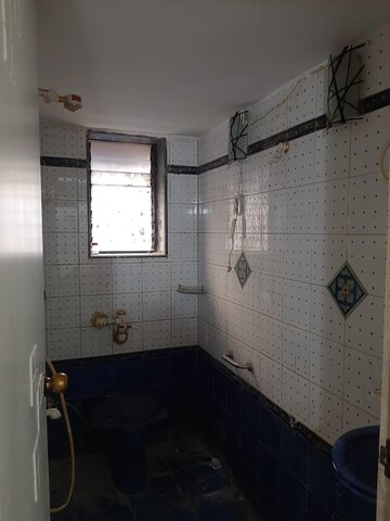 Bathroom in 2 BHK Apartment at Bhagya Nagar CHSL, Mahim West – for Rent