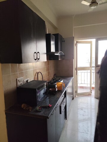 Kitchen in 2.5 BHK Apartment at Aims Golf City, Sector 75 – for Sale