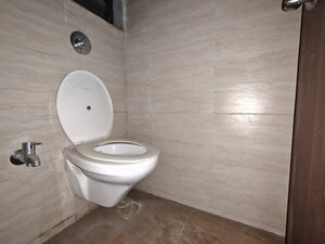 Bathroom in 1 BHK Apartment at Unnati Woods CHS, Kasarvadavali – for Rent