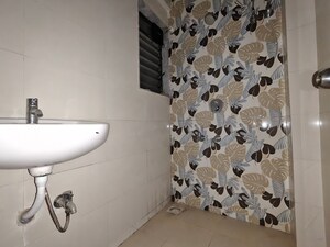 Bathroom in 1 BHK Apartment at Unnati Woods CHS, Kasarvadavali – for Rent