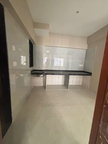 Kitchen in 1 BHK Apartment at Raunak Unnathi Woods Phase 4 And 5, Ghodbunder Road – for Sale