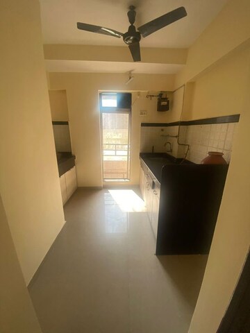 Kitchen in 1 BHK Apartment at Raunak Unnathi Woods Phase 6, Ghodbunder Road – for Sale