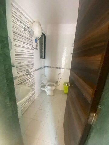Bathroom in 1 BHK Apartment at Raunak Unnathi Woods Phase 6, Ghodbunder Road – for Sale