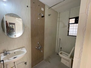 Bathroom in 2 BHK Apartment at Amey River View , Anand Nagar – for Rent