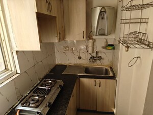 Kitchen in 2 BHK Apartment at Amrapali Golf Homes, Sector 4 Greater Noida – for Sale