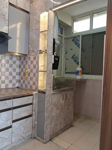 Kitchen in 2 BHK Apartment at Amrapali Golf Homes, Sector 4 Greater Noida – for Sale