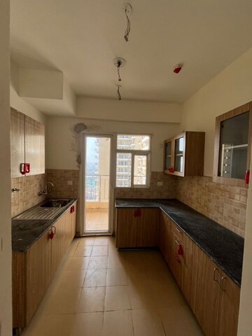 Kitchen in 4 BHK Apartment at Amrapali Heartbeat City, Sector 107 – for Rent