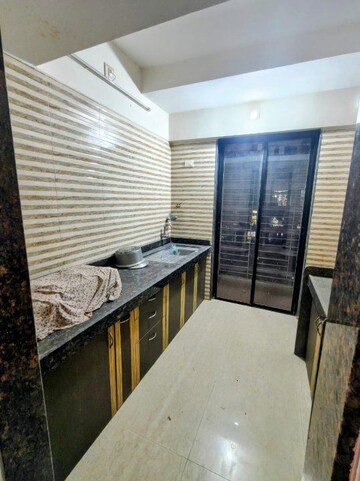 Kitchen in 1 BHK Apartment at Tharwani Vedant Millenia, Titwala – for Sale