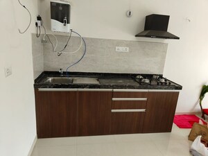 Kitchen in Studio Apartment at Gera World of Joy, Kharadi – for Rent