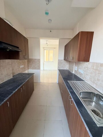 Kitchen in 2 BHK Apartment at Amrapali Heartbeat City, Sector 107 – for Rent