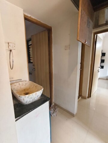 Bathroom in 1 BHK Apartment at Unnati Woods CHS, Kasarvadavali – for Rent