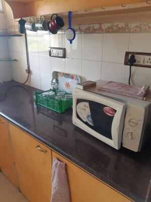 Kitchen in 1 BHK Apartment at Eden Woods complex, Manpada – for Rent