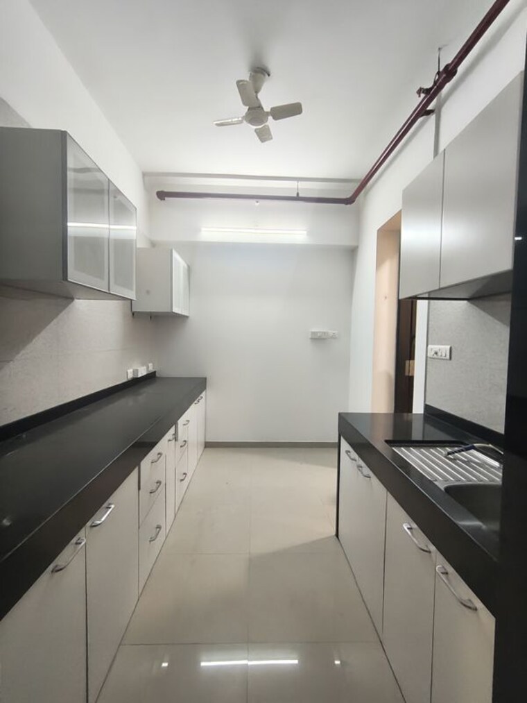 Kitchen, peninsula-celestia-spaces 3.5 Bedroom 1450 Sq.Ft. Apartment In Parel Mumbai 10151626