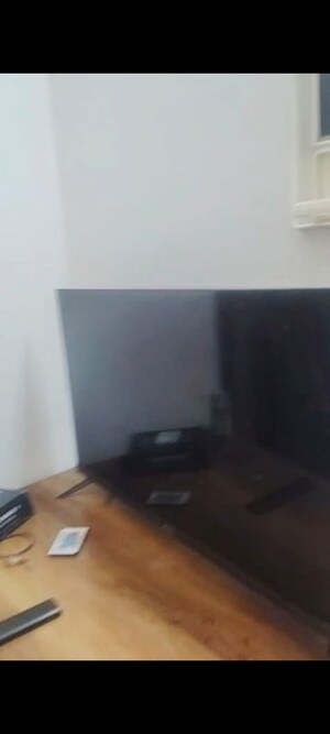 Living Room in 2 BHK Apartment at AIMS Golf Town, Sector 4 Greater Noida – for Rent