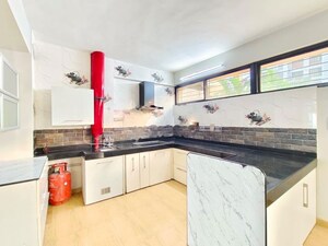 Kitchen in 4 BHK Apartment at Mont Vert Belair, Bhugaon – for Rent